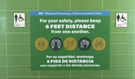 A social distancing sign hangs in front of CVHS' restrooms.