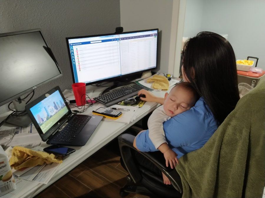Calculus teacher Stephanie Chen continues communicating with students online while her 6-month-old son Jacob sleeps in her arms. 