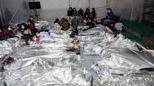 Migrant minors line up to sleep inside a detention center in El Paso, TX. 