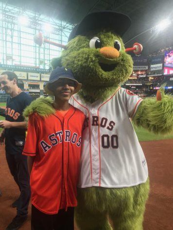 Austin Gordon standing next to Orbit after throwing the first pitch. 