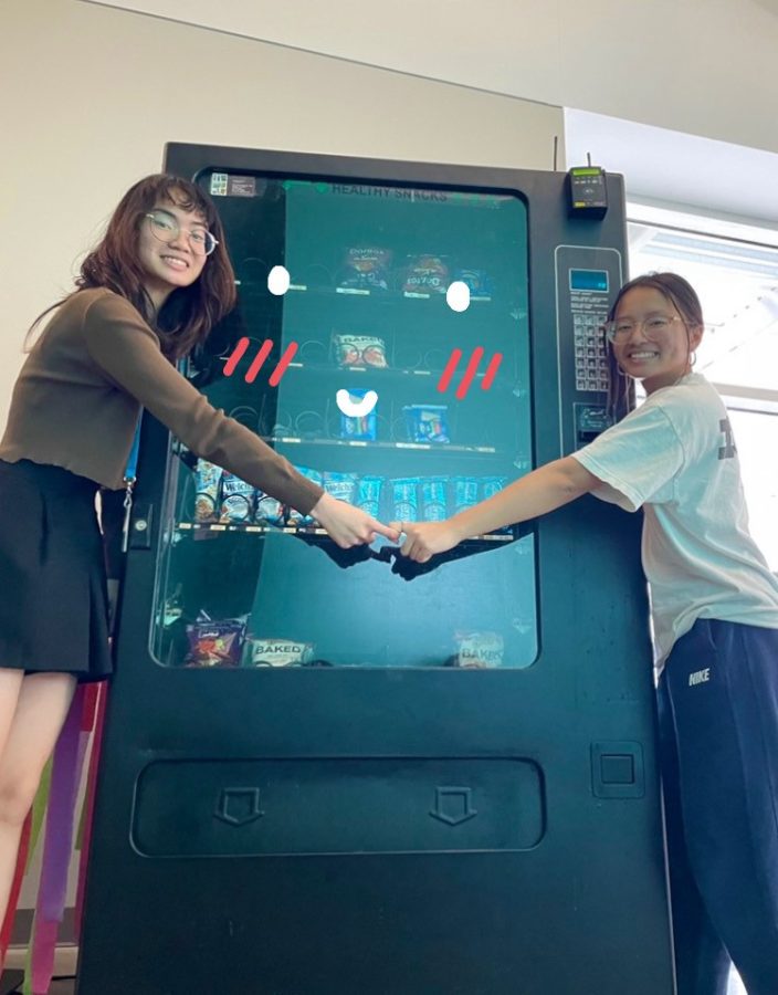 The authors hugging the vending machine, it smiles back affectionately. 