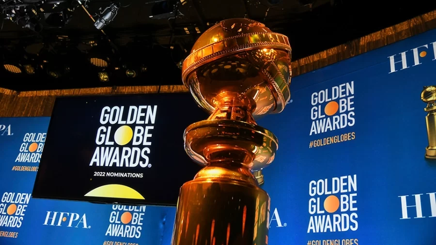 A Golden Globe award shines in the spotlight in front of the public