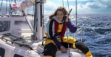 Teagan Croft as Jessica Watson sitting at the front of the sailboat talking on a satellite phone. [Netflix]