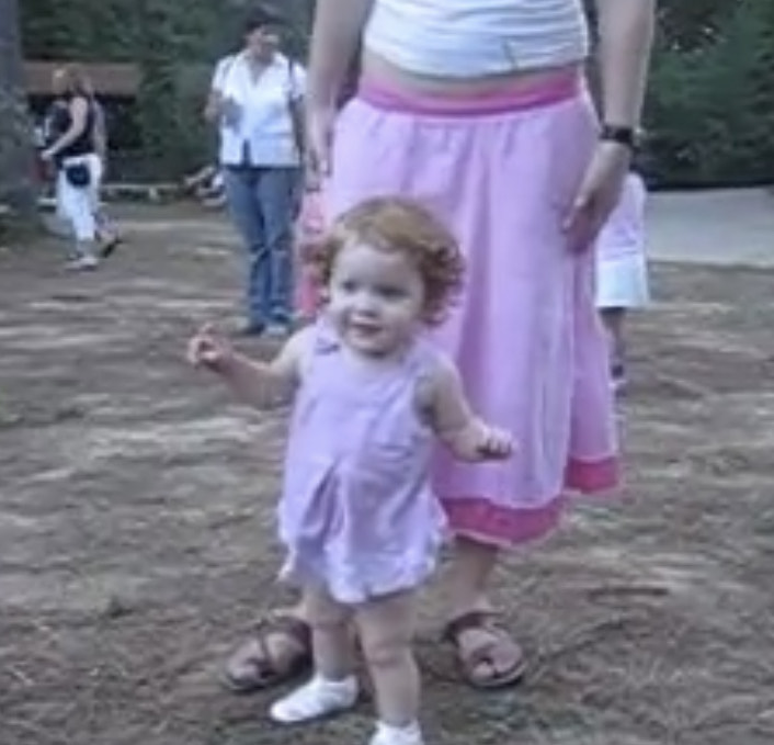 My cousin stands behind me as I attend the Texas Renaissance Festival for, most likely, the first time. My dad records us.