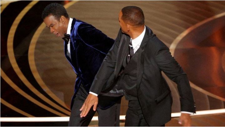 A photo of Will Smith slapping Chris Rock during the 2022 94th Academy Awards presentation of the nominees for Best Documentary Feature
