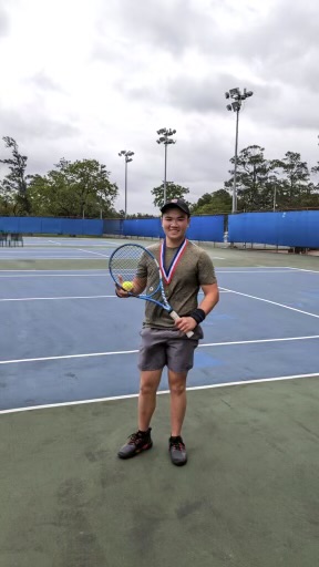 Thanh-Tri Nguyen and his first place medal after winning tennis Districts with CVHS's tennis team.