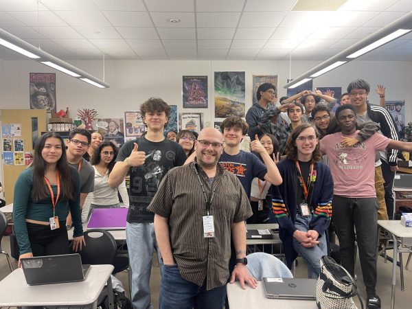Mr. Ostrovsky smiling for the camera with his fifth period class.