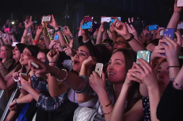 Phones have become a staple of concerts, including this Fifth Harmony concert from 2015. | Image credit: Theo Wargo/Getty Images