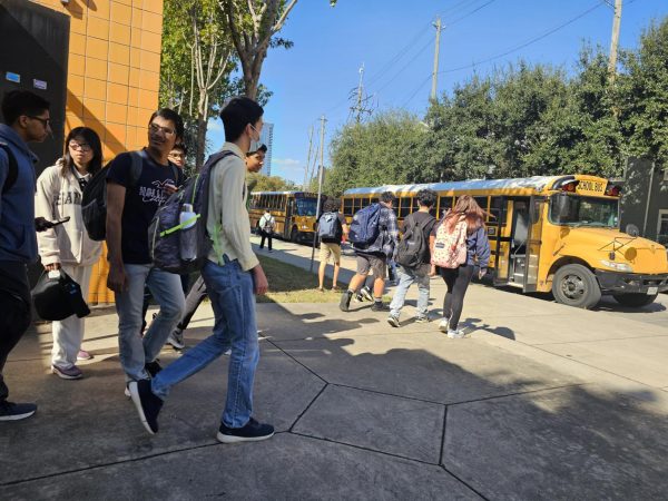 Students line up outside the west end of the CVHS building to board their buses on time.