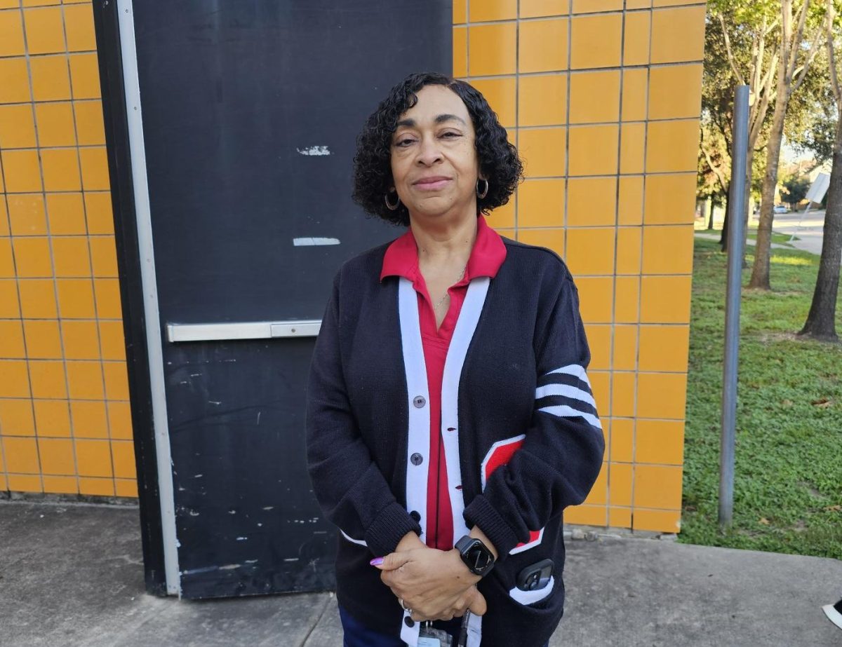 Beverly Wilson stands by the bus stop greeting students with a smile.