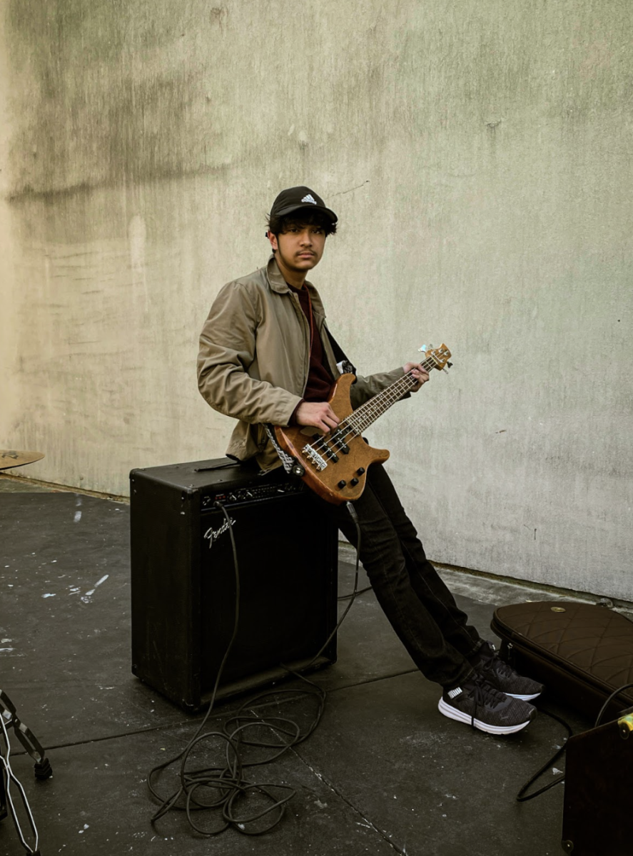 Junior Shawn Vaddi strums some tunes at a School of Rock practice session! 