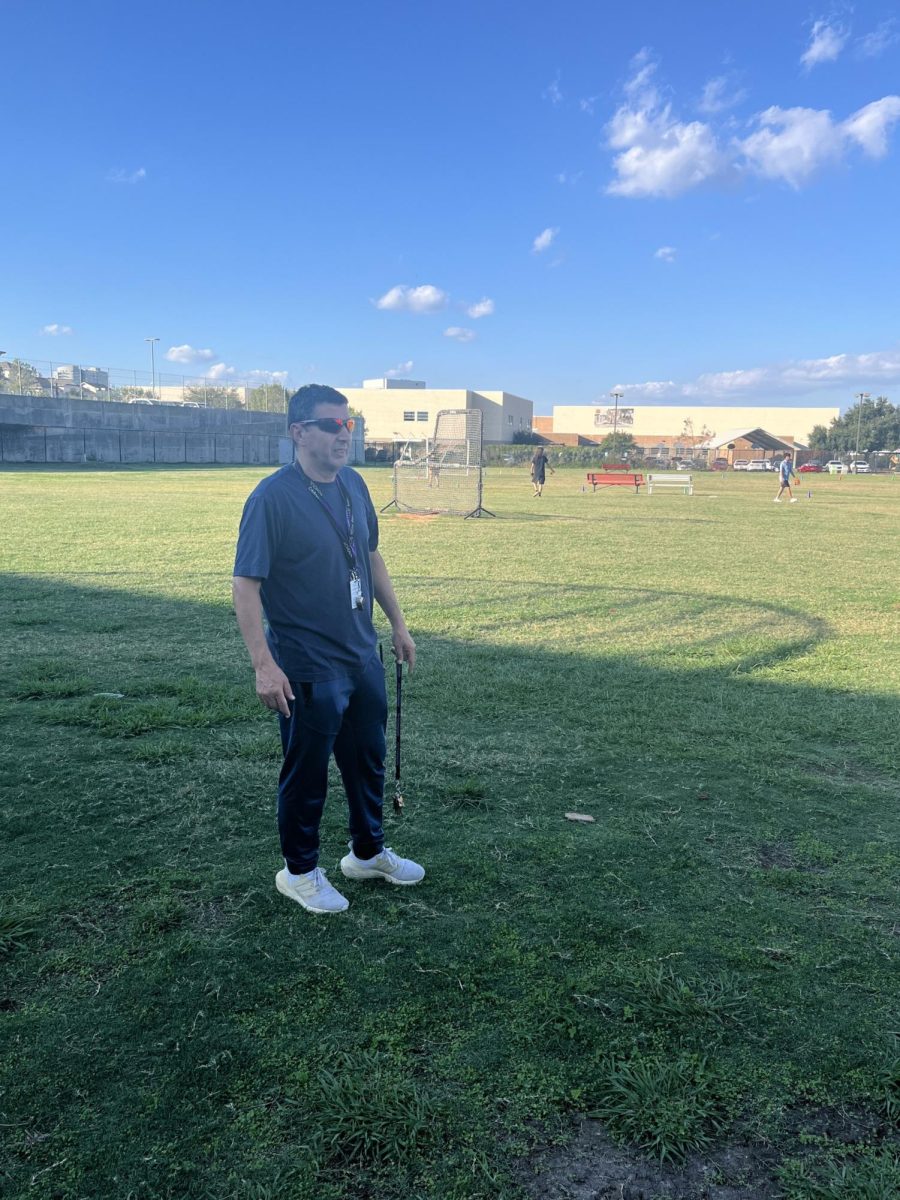 Coach Lamane outside watching the boy baseball team train for the upcoming season