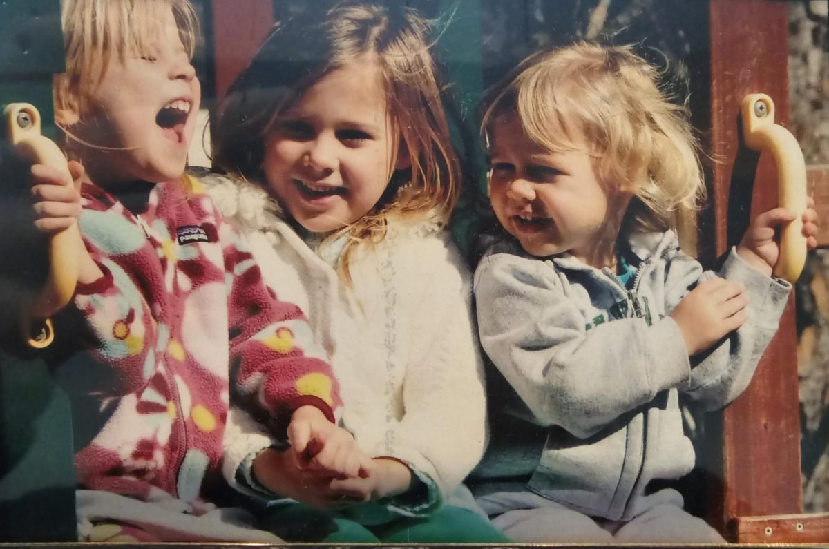 Caroline, Elaina, and I, sitting beneath the monkey bars on our play fort.