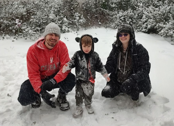 Pictured: Teacher Nathan Wendt strikes a pose in a heartwarming moment as he enjoys the snow with his wife and son. This is a moment his family will never forget as they made a memory of his son’s first snow day. His family embraces this rare snowfall with his and his family’s smiles reflecting the joy that the snow brought to Houston.
