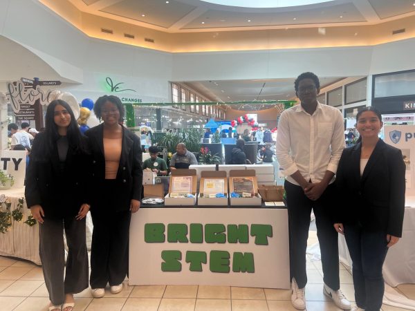 Members of Carnegie's JA club company, BrightSTEM, pose by their booth at the Junior Achievement Trade Fair.