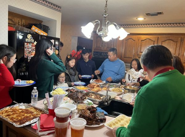 Thanksgiving dinner at my family's house. All members on my mom's side of my family are gathered around the countertop for food.