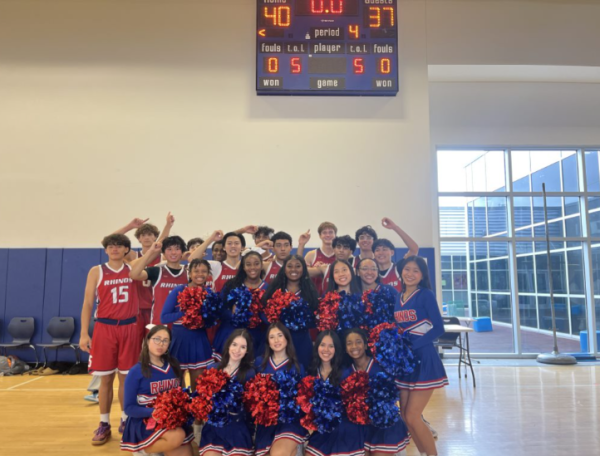 Photo of CVHS boys basketball team and CVHS cheerleader.