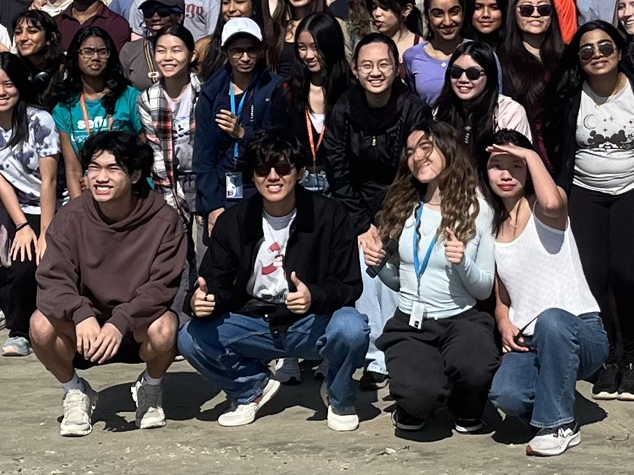 Daiki Sakai, front row second from left, poses for a photo at Galveston for the annual Galveston beach cleanup.