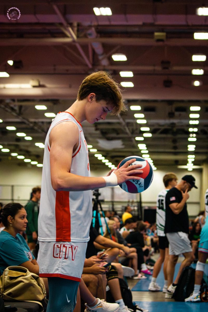 Max Philippe readies himself as he prepares to serve in a volleyball match.