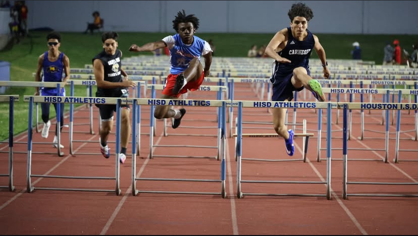 Cesar competes against others in the 110 meter hurdle event at the Varsity 21-5A District meet.